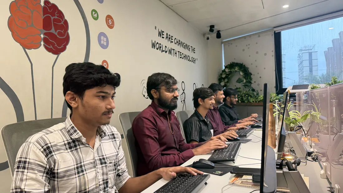 Team members along the mural wall