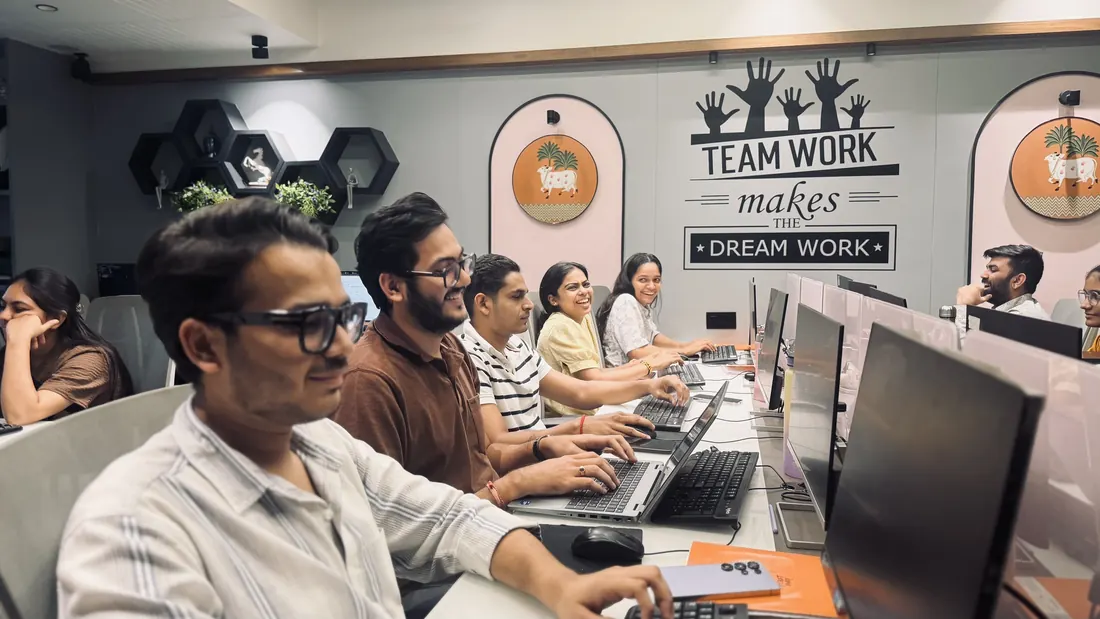 At a laptop with colleagues