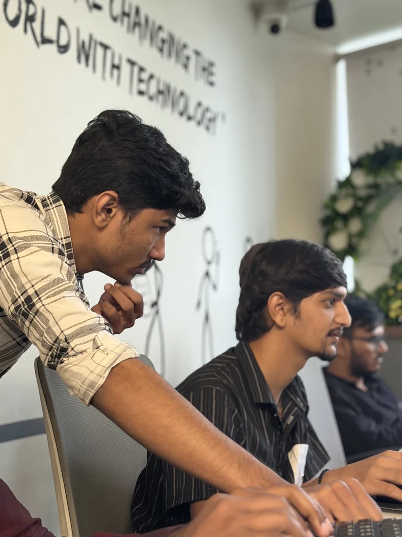 Colleagues working through a problem at their desks