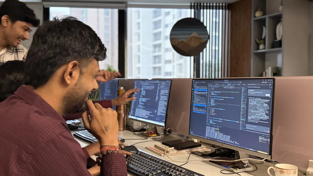 Developer at a multi-monitor desk
