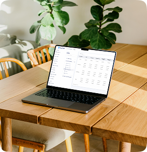 Laptop on a wooden table showing the EazyRide fare and pricing table